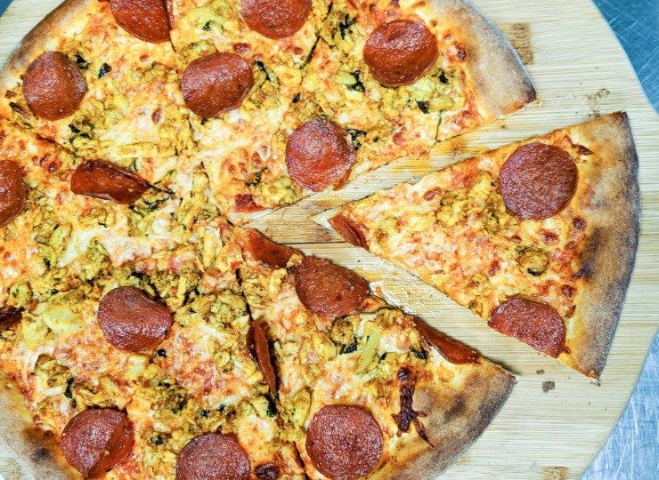 Best Pizza in Paisley, Barrhead and Johnstone for Delivery and Takeaway Pepperoni pizza sliced and sitting on a wooden board